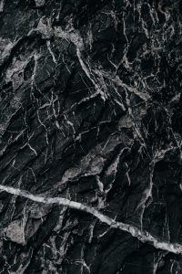 Close-up of intricate black marble texture with white veining.