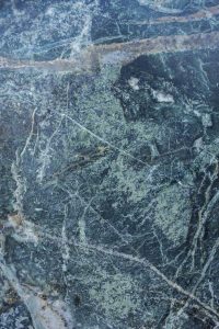 High-resolution image of a textured stone surface with natural blue-green hues and intricate patterns.